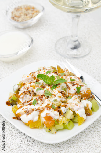 Photo: fruit salad with nuts, yogurt and mint, vertical fruit salad with nuts, yogurt and mint, vertical