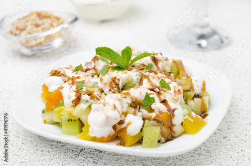 Photo: fruit salad with nuts, yogurt and mint garnished with yogurt fruit salad with nuts, yogurt and mint garnished with yogurt