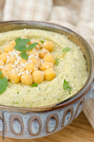 Photo: Hummus with cilantro, closeup, selective focus Hummus with cilantro, closeup, selective focus