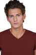 Serious young guy looking at you against a white background
