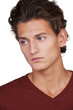 Serious young guy looking away against a white background
