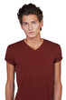 Serious young guy looking at you against a white background