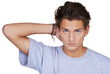 Serious young guy looking at you with his hand in his hair