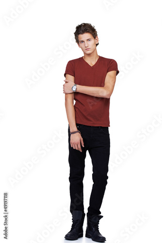 Photo: Uncomfortable and awkward looking guy isolated against a white b Uncomfortable and awkward looking guy isolated against a white b