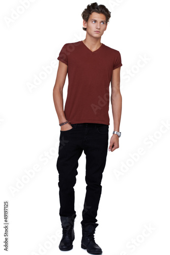 Photo: Young guy standing isolated on white and looking away Young guy standing isolated on white and looking away