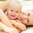 Mother and daughter play in the bedroom