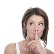 Playful woman making a shushing gesture