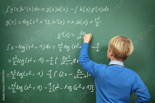 Photo: Schoolboy at the Blackboard with Formulas Schoolboy at the Blackboard with Formulas