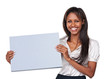 Studio shot of an attractive woman holding up a blank sign for c