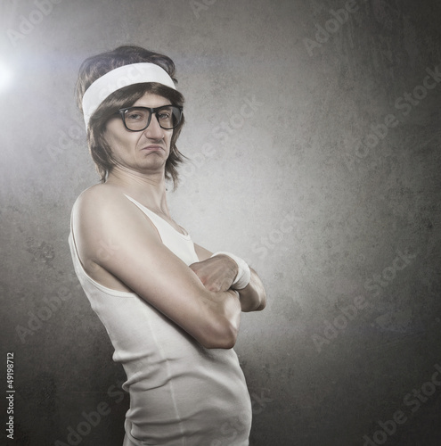 Photo: Funny retro sport nerd with serious face expression Funny retro sport nerd with serious face expression