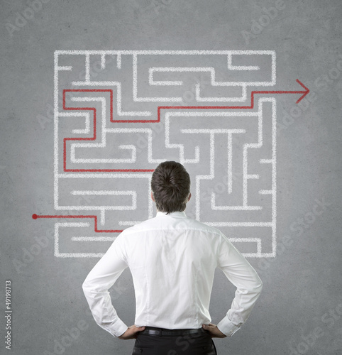 Photo: Confused businessman looking at the labyrinth Confused businessman looking at the labyrinth