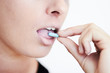 A young woman taking a pill - Addiction