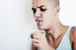 A young man smoking a joint and exhaling