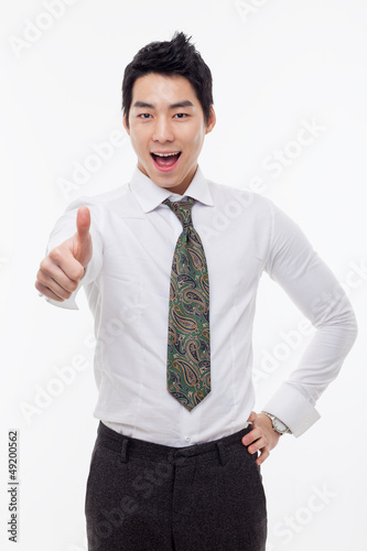 Photo: Showing thumb young Asian business man. Showing thumb young Asian business man.