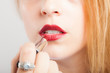 Woman applying lipstick