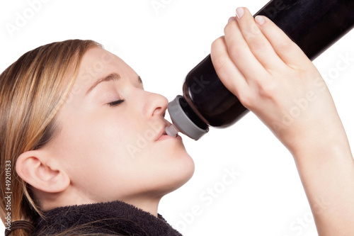 Photo: Woman drinking from a sports bottle Woman drinking from a sports bottle