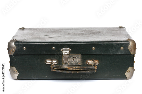 Photo: Old green suitcase with metal corners lying on the floor Old green suitcase with metal corners lying on the floor