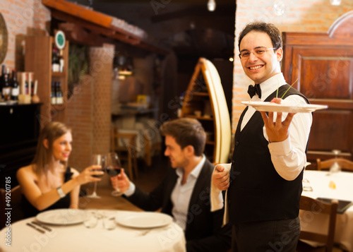 Photo: Waiter serving dinner Waiter serving dinner