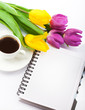 Flowers, coffee and notebook.