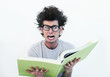 A stressed out hipster looking at how much he has to study