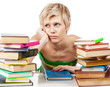 Photo: Young student woman with lots of books studying for exams Young student woman with lots of books studying for exams