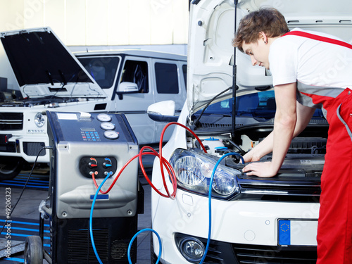 Photo: Car mechanic checking the air handling unit of a car Car mechanic checking the air handling unit of a car