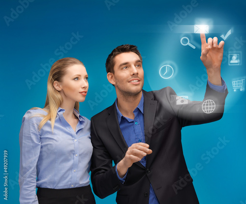 Photo: man and woman working with virtual screen man and woman working with virtual screen