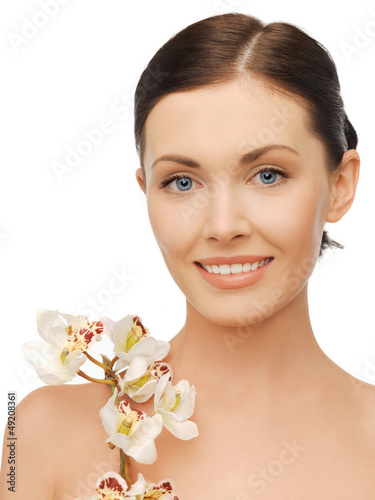 Photo: lovely woman with orchid flower lovely woman with orchid flower