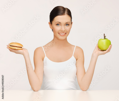 Photo: woman with hamburger and apple woman with hamburger and apple