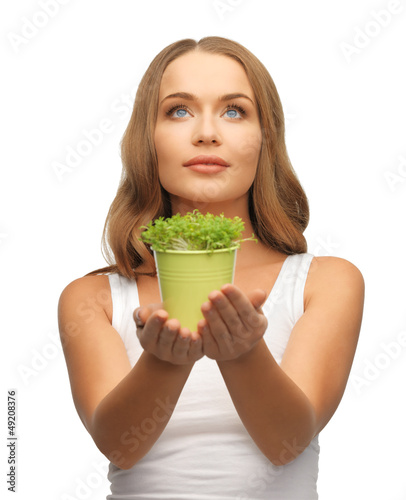 Photo: woman with green grass in pot woman with green grass in pot