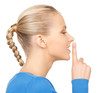 happy woman with finger on lips
