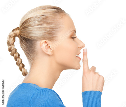 Photo: happy woman with finger on lips happy woman with finger on lips
