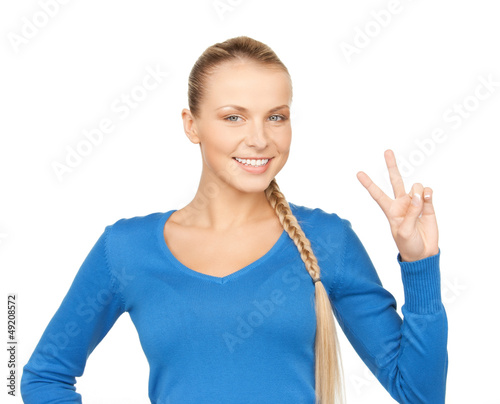 Photo: young woman showing victory sign young woman showing victory sign