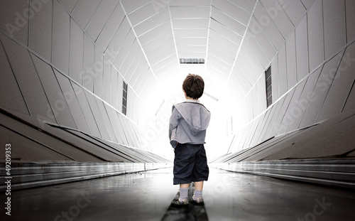 Photo: Child walking towards the tunnel Child walking towards the tunnel