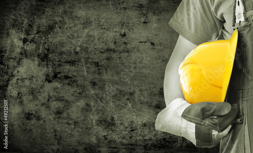 Photo: Worker and grunge texture in background Worker and grunge texture in background