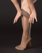 A woman takes off stockings