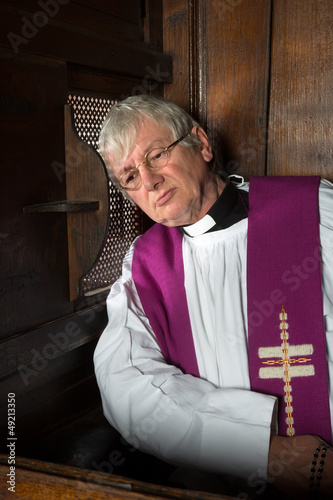 Photo: Vicar in confession booth Vicar in confession booth