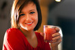 Smiling woman drinking a cocktail