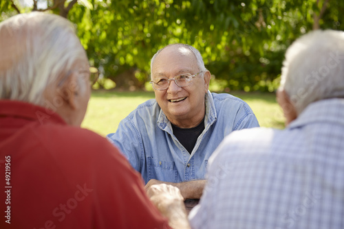 Photo: Group of senior men having fun and laughing in park Group of senior men having fun and laughing in park