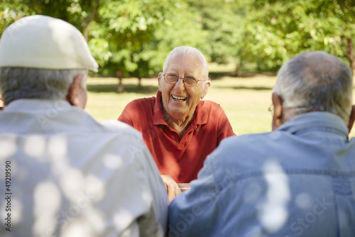 Photo: Group of senior men having fun and laughing in park Group of senior men having fun and laughing in park