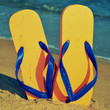 Photo: flip-flops on the sand of a beach flip-flops on the sand of a beach