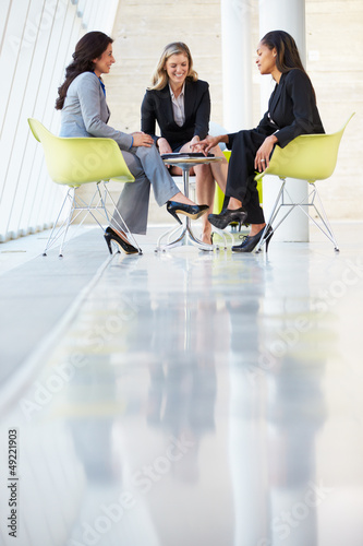 Photo: Three Businesswomen Meeting Around Table In Modern Office Three Businesswomen Meeting Around Table In Modern Office