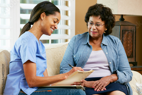 Photo: Nurse Making Notes During Home Visit With Senior Female Patient Nurse Making Notes During Home Visit With Senior Female Patient