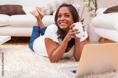 Photo: Young happy indian woman using a laptop Young happy indian woman using a laptop
