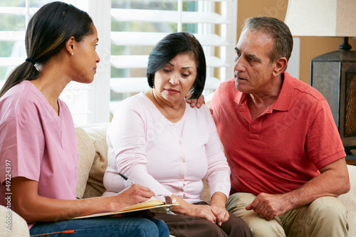 Photo: Nurse Making Notes During Home Visit With Senior Couple Nurse Making Notes During Home Visit With Senior Couple