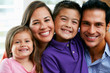 Foto: Family Sitting On Sofa At Home Together Family Sitting On Sofa At Home Together