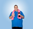 Fat man in the gym with a water bottle
