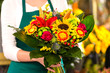 Photo: Florist holding bouquet colorful flowers shop assistant Florist holding bouquet colorful flowers shop assistant