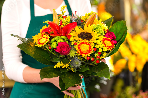 Photo: Florist holding bouquet colorful flowers shop assistant Florist holding bouquet colorful flowers shop assistant