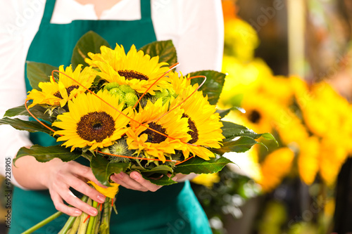Photo: Bouquet sunflowers flower shop female florist holding Bouquet sunflowers flower shop female florist holding